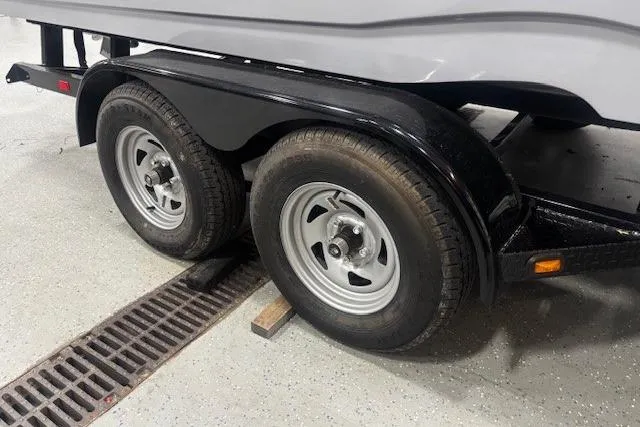 Slide: The Image of 2023 NauticStar 243 DC boat on trailer, parked outside dealership. - 40