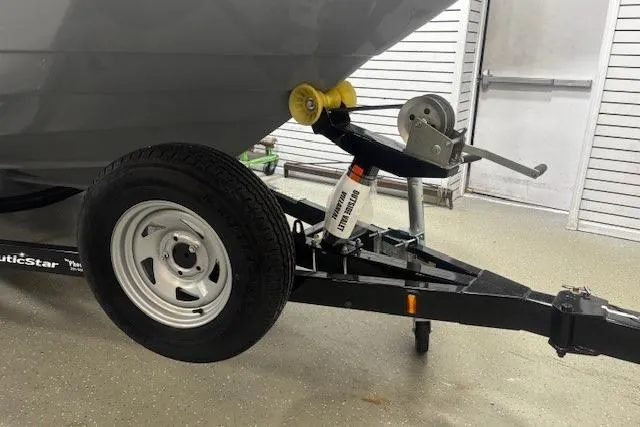 Slide: The Image of 2023 NauticStar 243DC Sport Deck with Mercury outboard engine in a showroom. - 41