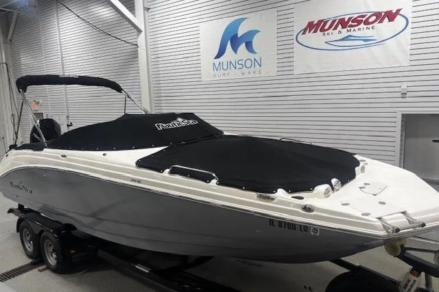 Slide: The Image of 2023 NauticStar 243DC Sport Deck boat in showroom with protective cover. - 45