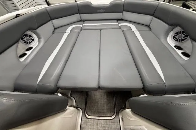 Slide: The Image of 2023 NauticStar 243DC Sport Deck boat on trailer in garage setting. - 47