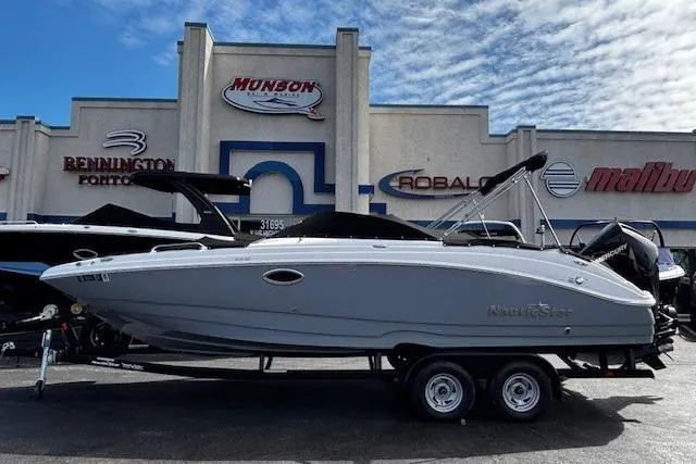 Slide: The Image of 2023 NauticStar 243DC Sport Deck boat in showroom with protective cover. - 48