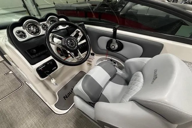 Slide: The Image of 2023 NauticStar 243DC Sport Deck boat with sleek design and spacious seating. - 5