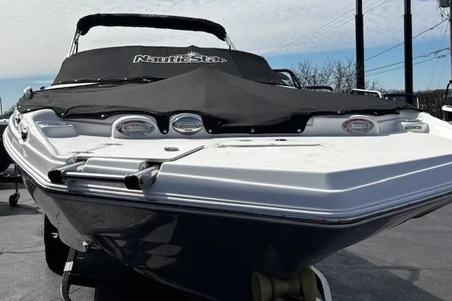 Slide: The Image of 2023 NauticStar 243DC Sport Deck boat interior with gray cushioned seating and integrated speakers. - 50