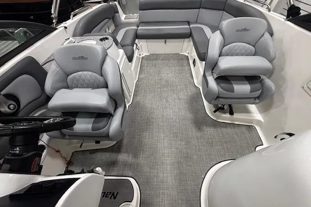 Slide: The Image of 2023 NauticStar 243DC Sport Deck steering wheel and dashboard, featuring modern controls and gauges. - 6