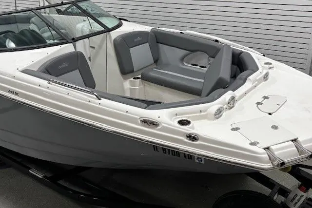 Slide: The Image of 2023 NauticStar 243DC Sport Deck boat interior with steering wheel and cushioned captain's chair. - 7