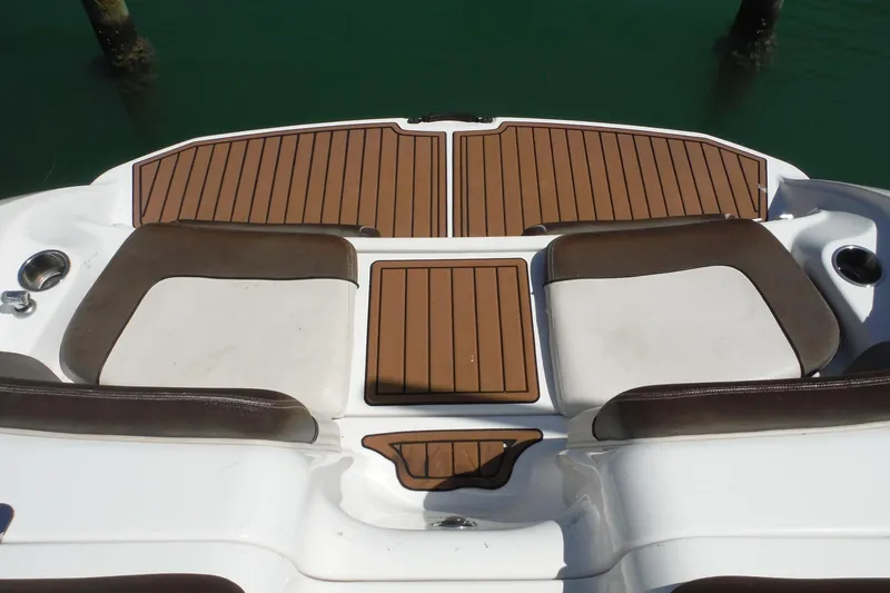 Slide: The Image of 2011 Yamaha Boats 242 Limited swim platform with cushioned seating and teak-style flooring. - 10