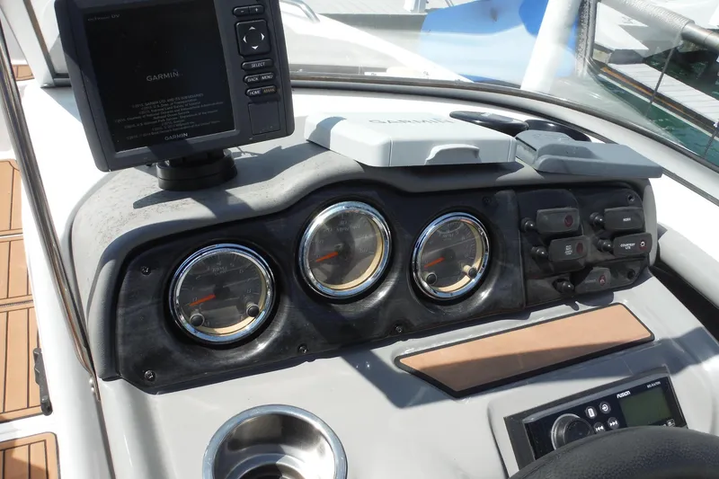 Slide: The Image of Dashboard of a 2011 Yamaha Boats 242 Limited with Garmin navigation system and gauges. - 11