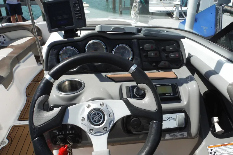 Slide: The Image of Steering console of a 2011 Yamaha Boats 242 Limited, featuring gauges and controls. - 12