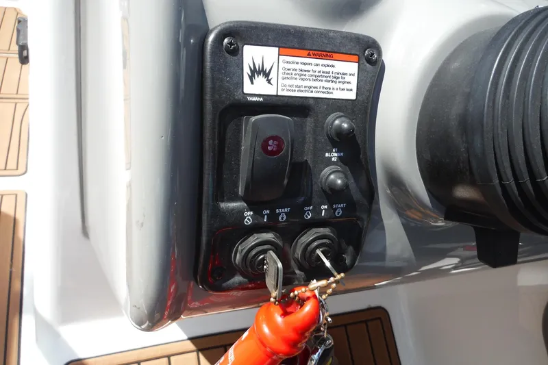 Slide: The Image of Control panel of a 2011 Yamaha Boats 242 Limited with ignition keys and warning label. - 17