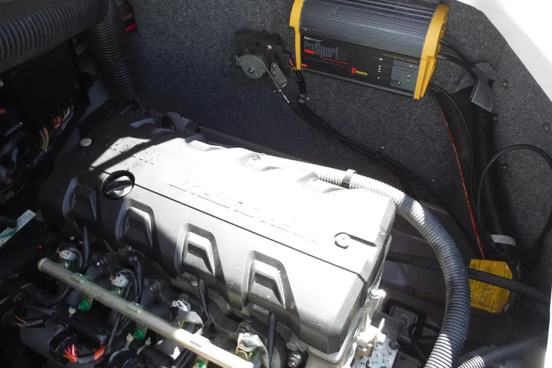 Slide: The Image of Engine compartment of a 2011 Yamaha Boats 242 Limited, featuring a ProSport12 charger. - 24
