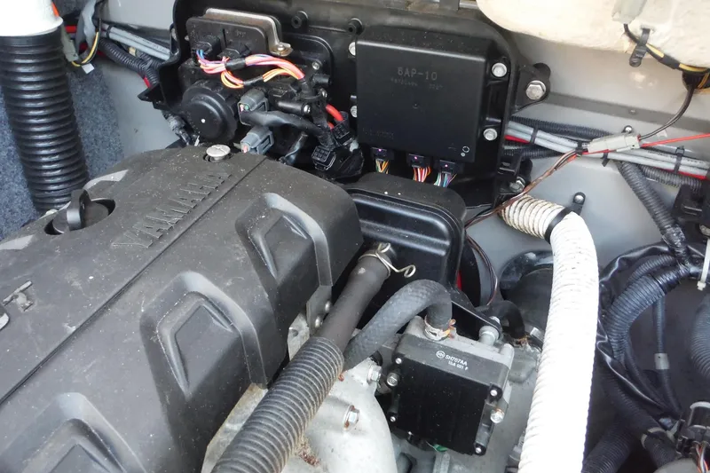 Slide: The Image of Engine compartment of a 2011 Yamaha Boats 242 Limited, showcasing wiring and components. - 30