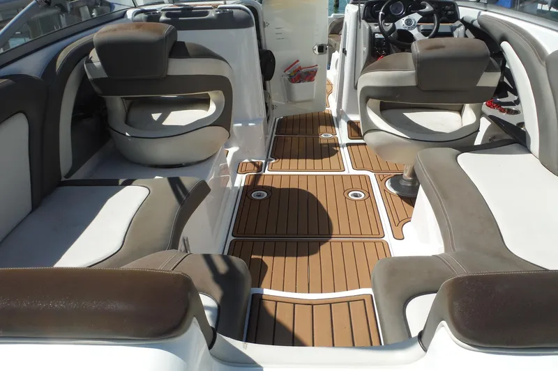 Slide: The Image of 2011 Yamaha Boats 242 Limited interior with brown and white seating and wood-style flooring. - 34