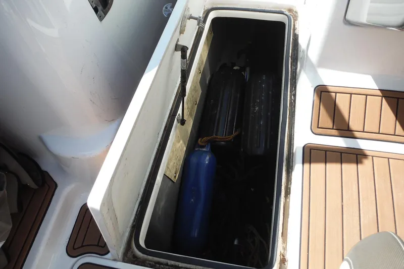 Slide: The Image of Storage compartment on 2011 Yamaha Boats 242 Limited, featuring fenders and marine equipment. - 37