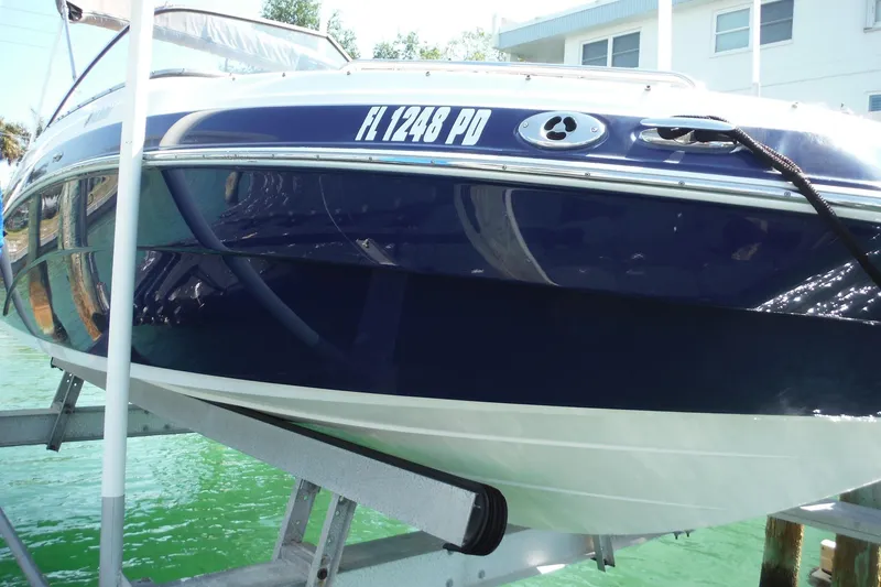 Slide: The Image of 2011 Yamaha Boats 242 Limited on lift, docked near waterfront property. - 42