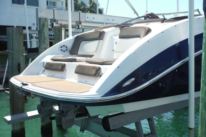 Slide: The Image of 2011 Yamaha Boats 242 Limited on lift, showcasing sleek design and comfortable seating. - 46