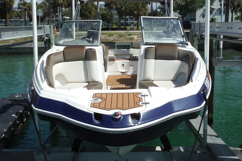 Slide: The Image of 2011 Yamaha Boats 242 Limited docked, featuring spacious seating and sleek design. - 49