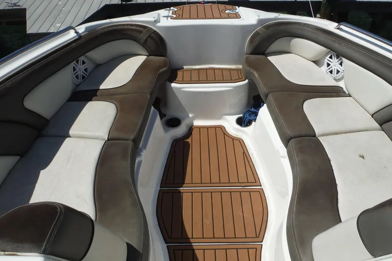 Slide: The Image of 2011 Yamaha Boats 242 Limited interior with brown and white seating, teak-style flooring. - 6
