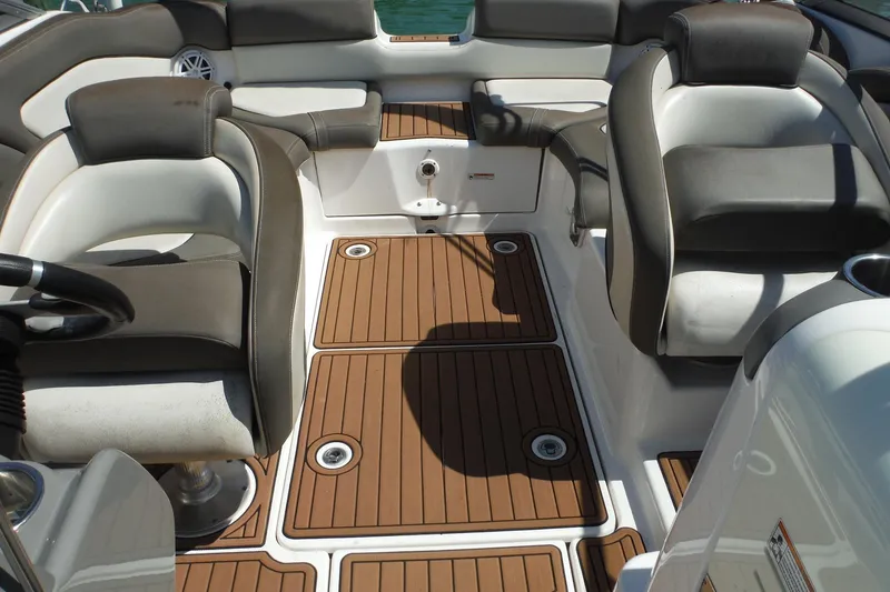 Slide: The Image of Interior of 2011 Yamaha Boats 242 Limited, featuring cushioned seating and teak-style flooring. - 7