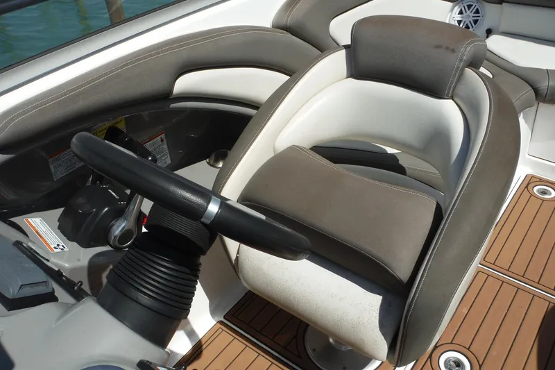 Slide: The Image of Steering area of 2011 Yamaha Boats 242 Limited with cushioned seat and controls. - 8