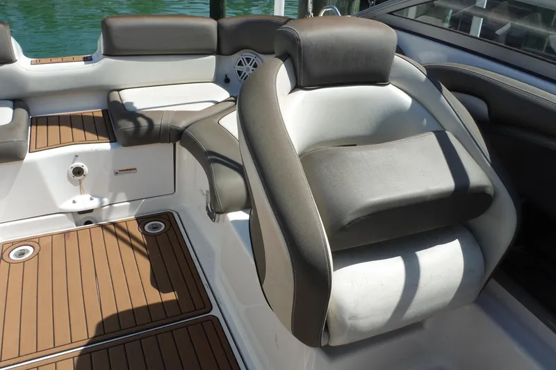Slide: The Image of Interior seating of a 2011 Yamaha Boats 242 Limited, featuring cushioned seats and teak-style flooring. - 9