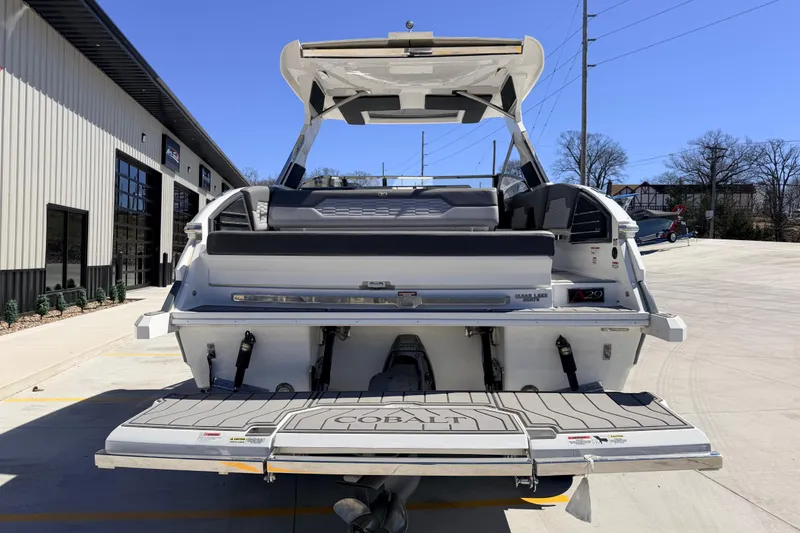 Slide: The Image of 2023 Cobalt A29 boat rear view, showcasing swim platform and sleek design in a sunny outdoor setting. - 10