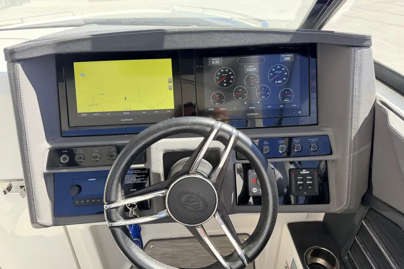 Slide: The Image of 2023 Cobalt A29 boat dashboard with Garmin navigation displays and steering wheel. - 18