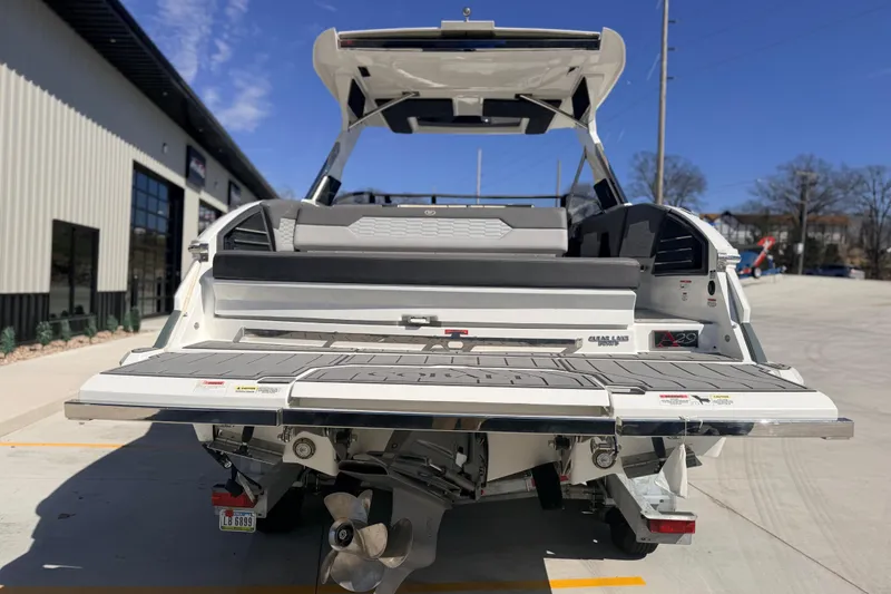 Slide: The Image of 2023 Cobalt A29 boat rear view with swim platform and outboard motor. - 2