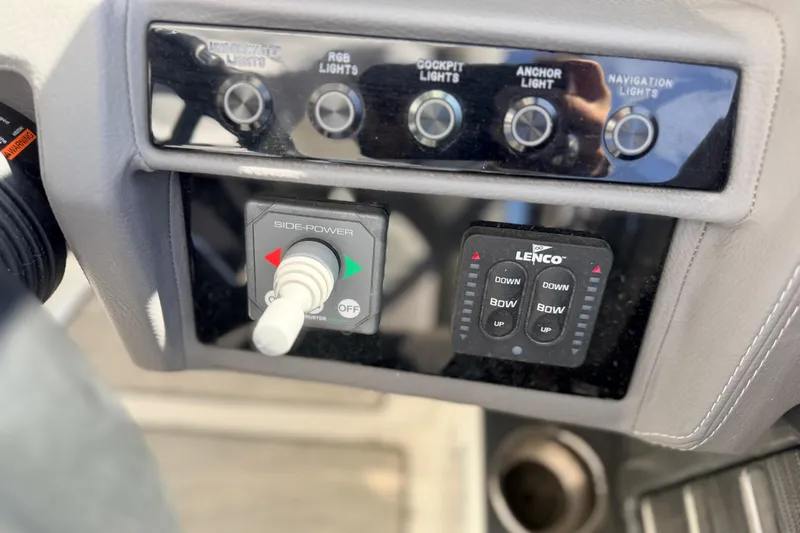 Slide: The Image of Control panel of a 2023 Cobalt A29 boat with lighting and thruster switches. - 21