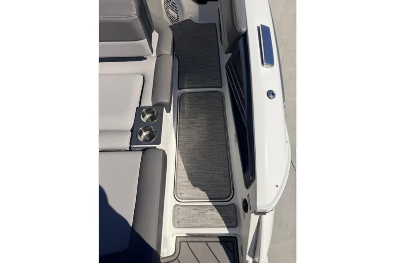 Slide: The Image of 2023 Cobalt A29 boat interior with cushioned seating and cup holders. - 6