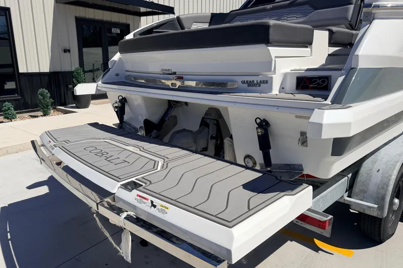 Slide: The Image of 2023 Cobalt A29 boat rear view with swim platform and trailer. - 11