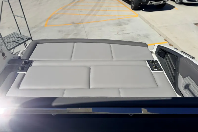 Slide: The Image of 2023 Cobalt A29 boat with spacious sunpad and cup holders, parked outdoors. - 14