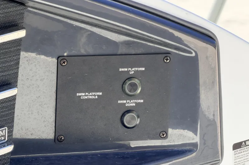 Slide: The Image of Control panel for swim platform on 2023 Cobalt A29 boat, featuring up and down buttons. - 28