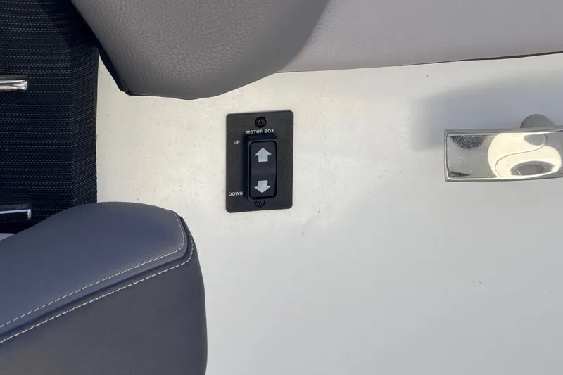 Slide: The Image of 2023 Cobalt A29 boat motor box control panel with up and down arrows. - 30