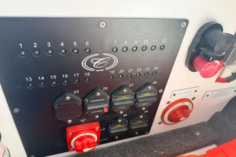 Slide: The Image of Control panel of 2023 Cobalt A29 boat with switches and circuit breakers. - 33