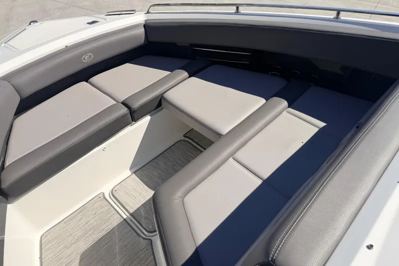 Slide: The Image of Interior seating of 2023 Cobalt A29 boat, featuring gray cushioned seats. - 8