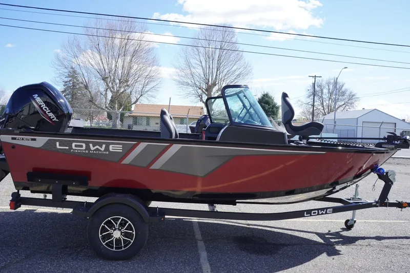 Slide: The Image of 2026 Lowe Fishing Machine 1675 WT boat on trailer, side view, outdoors. - 10