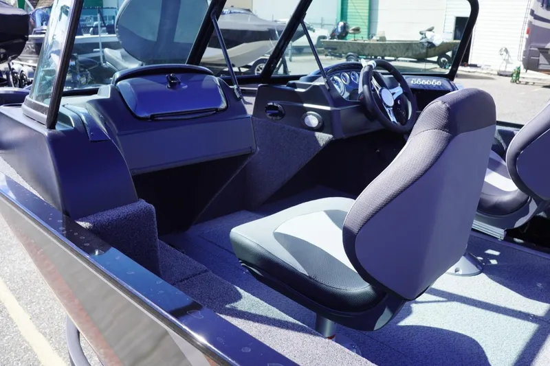 Slide: The Image of 2026 Lowe Fishing Machine 1675 WT interior with modern seating and dashboard design. - 17