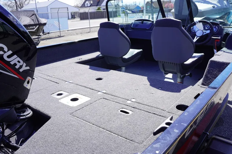 Slide: The Image of 2026 Lowe Fishing Machine 1675 WT interior with Mercury engine, spacious seating, and carpeted deck. - 18