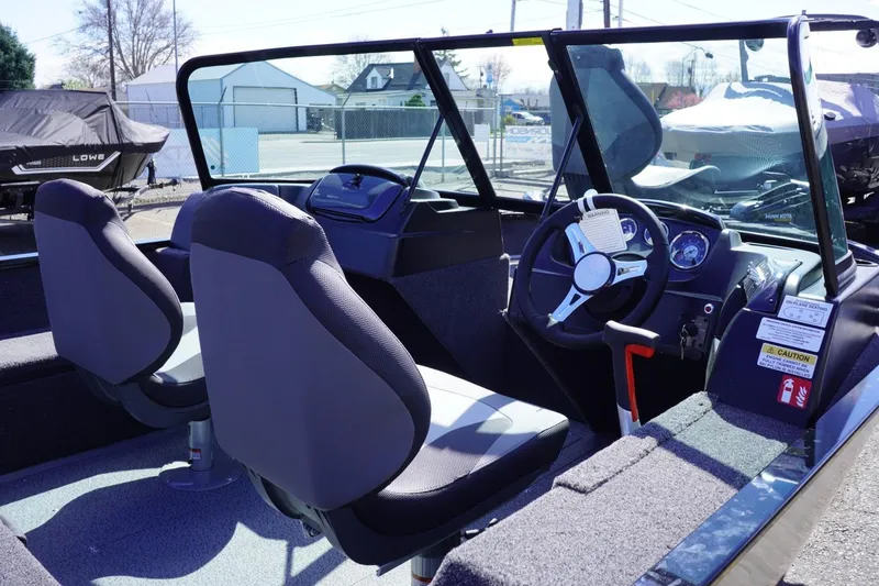 Slide: The Image of 2026 Lowe Fishing Machine 1675 WT interior with dual seats and steering console. - 19