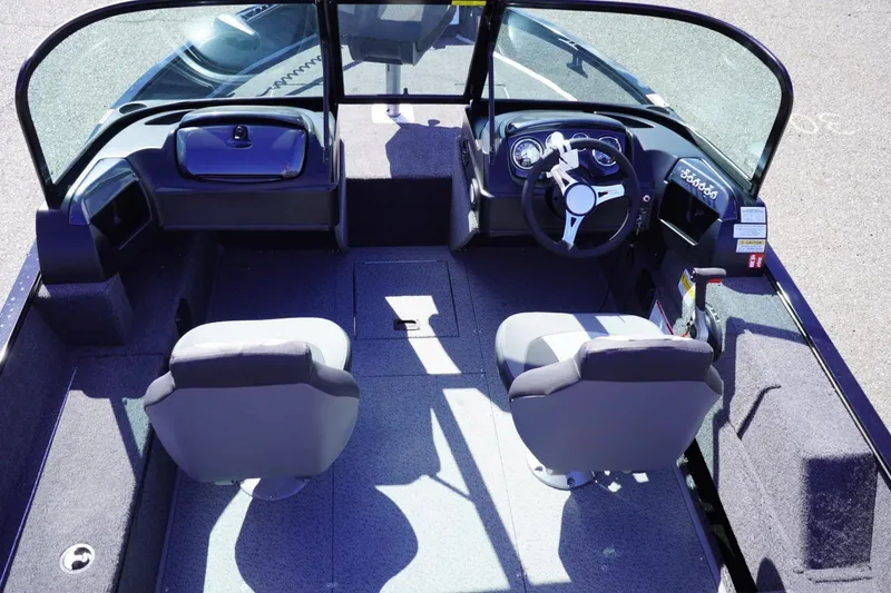 Slide: The Image of 2026 Lowe Fishing Machine 1675 WT interior with dual seats and steering console. - 20