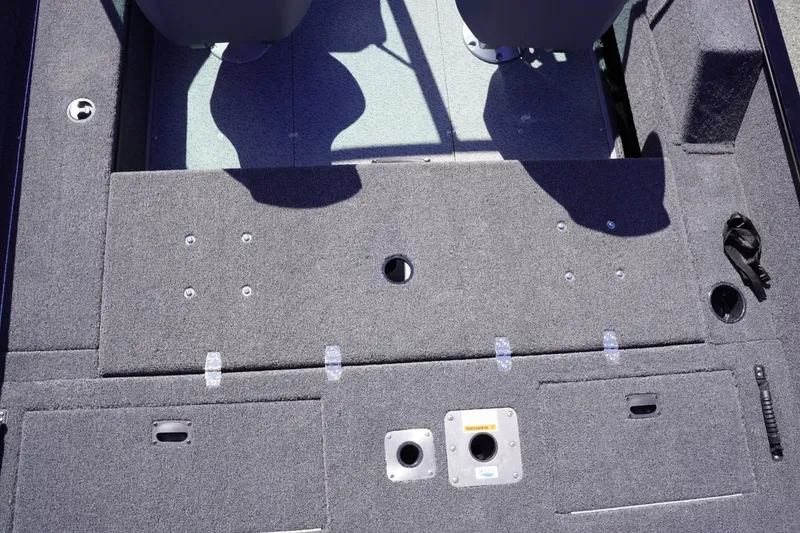 Slide: The Image of 2026 Lowe Fishing Machine 1675 WT interior deck with storage compartments and seating. - 21