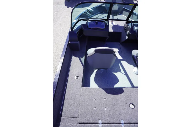 Slide: The Image of 2026 Lowe Fishing Machine 1675 WT interior with seating and dashboard view. - 22