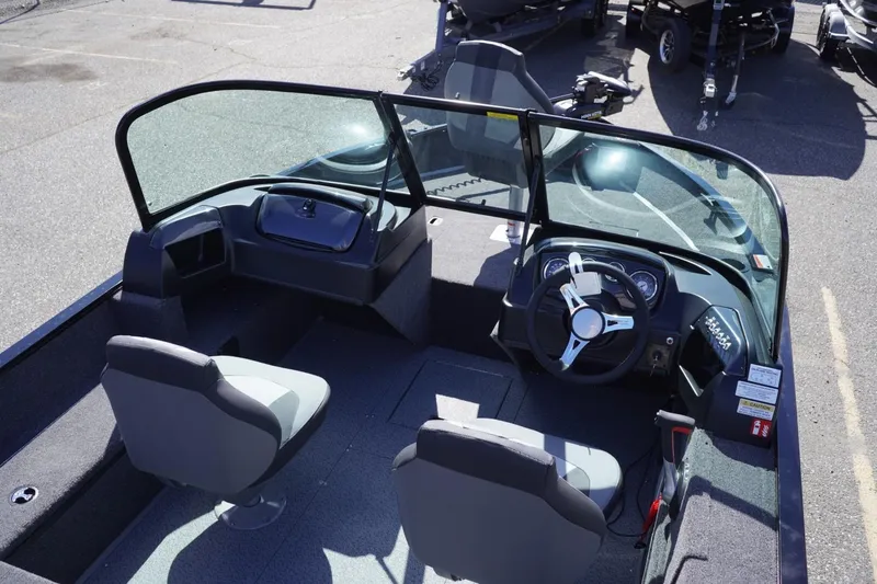 Slide: The Image of 2026 Lowe Fishing Machine 1675 WT interior with dual seats and steering console. - 23