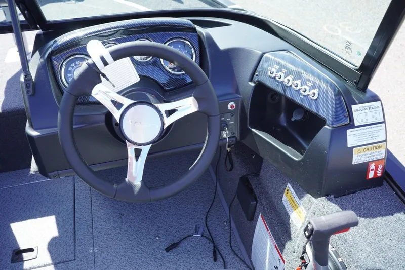 Slide: The Image of 2026 Lowe Fishing Machine 1675 WT dashboard with steering wheel and control panel. - 26