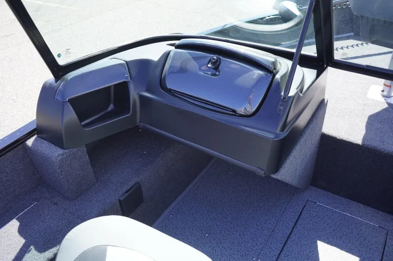 Slide: The Image of 2026 Lowe Fishing Machine 1675 WT interior with storage compartments and seating. - 27