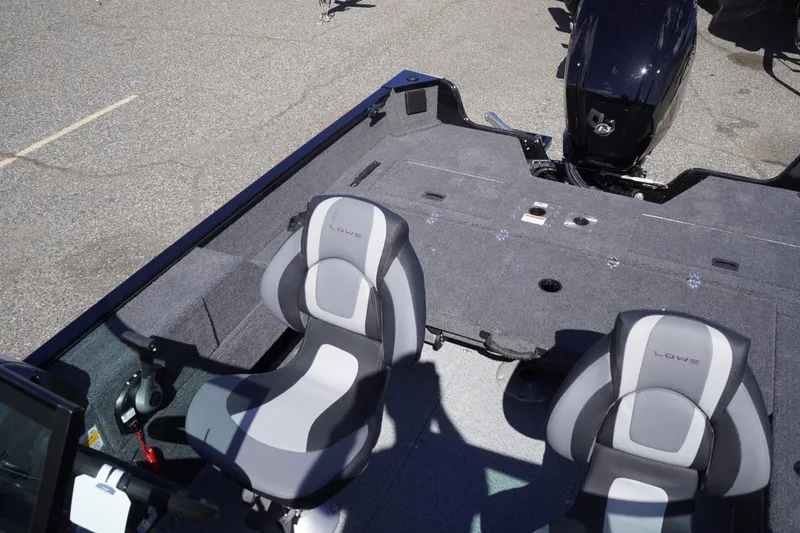 Slide: The Image of 2026 Lowe Fishing Machine 1675 WT boat interior with two seats and motor. - 32