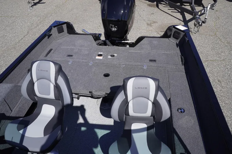 Slide: The Image of 2026 Lowe Fishing Machine 1675 WT interior with two seats and motor, ideal for fishing. - 33