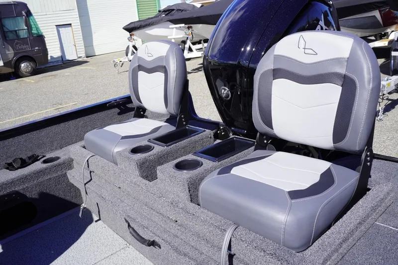 Slide: The Image of 2026 Lowe Fishing Machine 1675 WT interior with two cushioned seats and cup holders. - 36