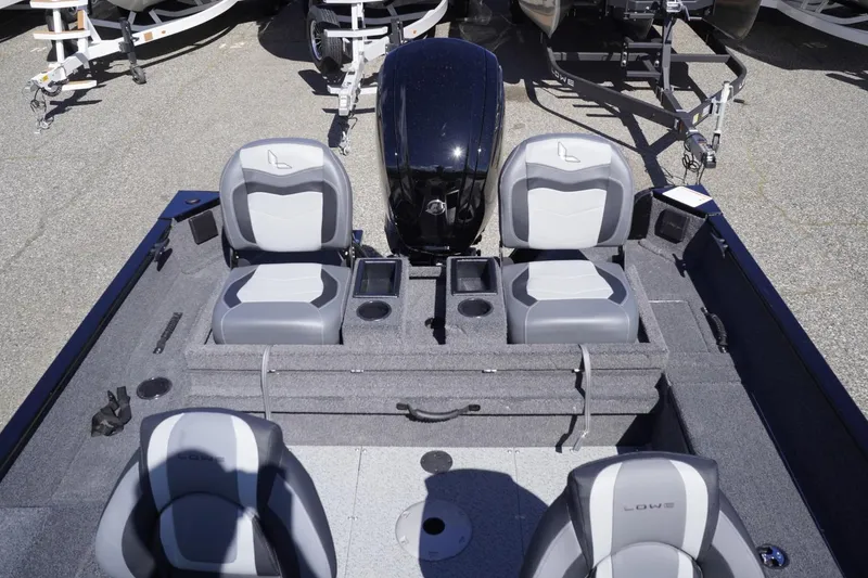 Slide: The Image of 2026 Lowe Fishing Machine 1675 WT interior with seating and motor, ideal for fishing trips. - 37