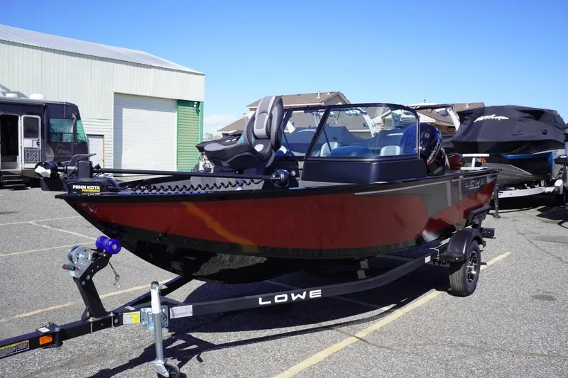 Slide: The Image of 2026 Lowe Fishing Machine 1675 WT boat on trailer, parked outdoors. - 4
